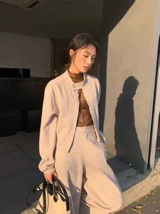 Minimalist beige two-piece casual set with zip-up sweatshirt and wide-leg pants