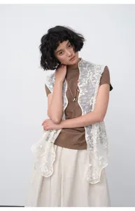 Detailed view of brown slim fit short sleeve T-shirt with lace vest layered over