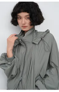 Close-up detail of a women's lightweight hooded sun protection jacket in sage green color.