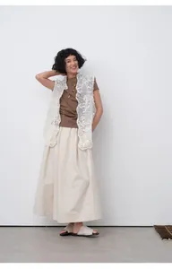 Model wearing brown Korean style short sleeve T-shirt with white lace vest and skirt