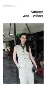 Street style view of a minimalist beige V-neck sleeveless vest for autumn layering