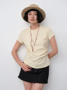 Asian model wearing a cream Korean-style slim fit waist pleat T-shirt with necklace and hat