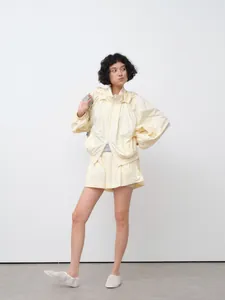 Lightweight cream hooded sun protection jacket set for women in minimalist studio setting.