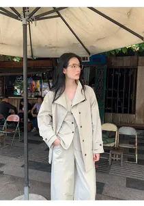 Minimalist cotton blend V-neck vest and wide-leg trousers set in an outdoor cafe.