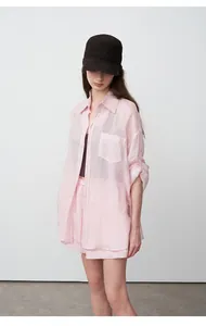 Full body detail showing the oversized fit and soft texture of the pink tencel shirt