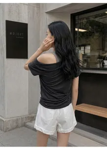 Back view of black cold-shoulder faux two-piece T-shirt showing chic waist ruching detail