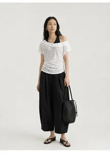 Detail view of a white off-the-shoulder faux two-piece T-shirt with 'CHILL' print.