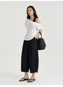 Detailed view of stylish women's off-shoulder layered T-shirt with waist ruching detail