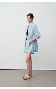 Detailed shot of a light blue tencel ramie loose-fit shirt and matching shorts