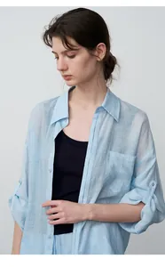 Close-up of a light blue tencel ramie shirt on a model, showing fabric texture and fit