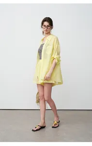 Detailed side view of a lightweight yellow tencel ramie shirt with matching shorts