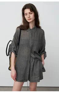 Model wearing a dark grey tencel ramie loose-fit shirt and shorts set for a minimalist look