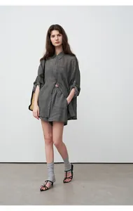 Full body view of a woman wearing a grey tencel ramie linen shirt and matching shorts.