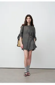 Full body look of a stylish minimalist gray loose tencel ramie shirt and shorts set