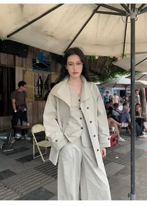 Outdoor street style shot of a beige minimalist cotton-blend V-neck waistcoat three-piece set
