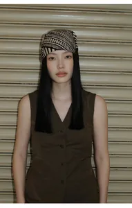Close-up view of the minimalist brown V-neck sleeveless cotton blend vest on a model