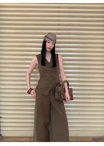 Full view of minimalist brown V-neck cotton blend sleeveless vest and wide-leg trousers