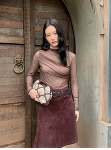 Vintage Maillard style burgundy suede asymmetric A-line skirt worn by a model in detail view