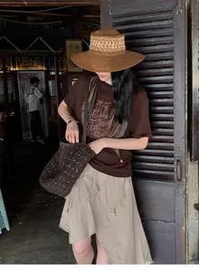 Woman wearing an early autumn asymmetrical textured midi skirt in a vintage setting