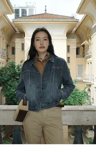 Stylish model wearing an American style gradient washed denim short jacket outdoors.