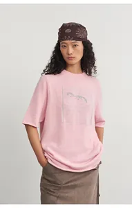Asian model wearing a stylish pink round neck knit top with silver jacquard design.