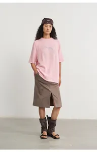 Detail view of pink loose knit top with silver jacquard horse pattern and crew neck