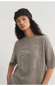 Loose fit round neck knit top with silver thread jacquard and half sleeves on model