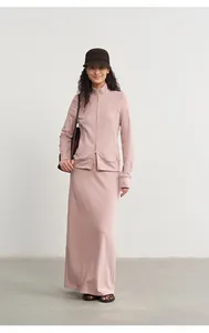 Asian model wearing a dusty rose modal knit maxi skirt and a matching zip-up jacket.