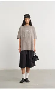 Asian woman model in oversized grey knit top with silver jacquard and black culottes
