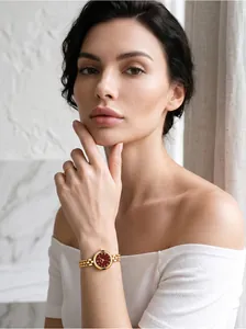Elegant close-up detail of Gedi vintage gold watch with red dial and beaded bracelet.