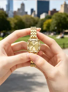Detailed macro shot of GEDI gold square quartz watch featuring an elegant metal steel strap
