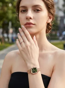 Detailed view of GEDI square green dial quartz watch with rose gold strap on wrist