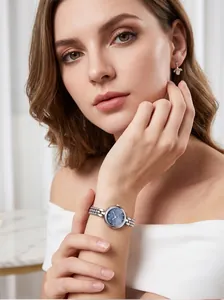 Close-up of elegant Gedi quartz watch with silver bead bracelet on model's wrist.