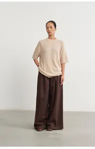 Detailed view of women's loose knitted top featuring elegant silver thread jacquard design