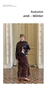 Full view of a retro printed mermaid maxi skirt styled with a brown leather jacket