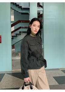 Fashion model wearing stylish high waist beige straight leg pants and green suede jacket