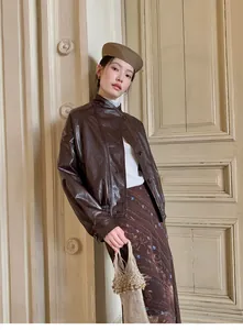 Detailed view of a vintage brown printed fishtail midi skirt in a retro setting