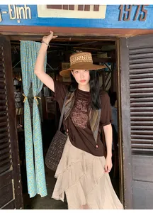 Asian woman wearing a layered asymmetric beige skirt in a vintage rustic cafe setting