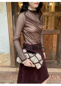 Vintage Maillard style burgundy A-line skirt styled with a brown draped mesh top
