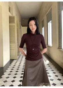 Elegant Asian model wearing a brown satin lace skirt and coffee half-sleeve top.