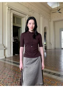 Full-body model view showing satin lace patchwork irregular skirt in a stylish indoor setting.