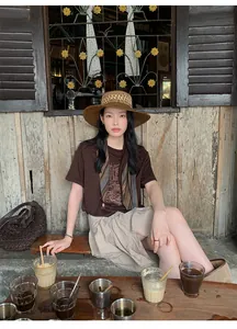Asian model posing in early autumn beige textured asymmetrical midi skirt in a rustic cafe