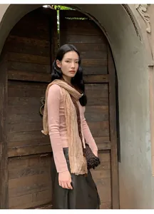 Fashionable slim-fit pink knitted cardigan paired with a two-tone pleated scarf