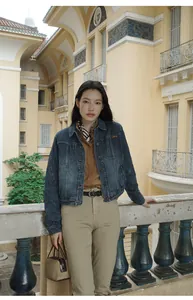 Full body view of a women's gradient wash short denim jacket with lapel and pockets