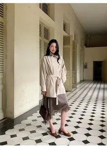 Full view of brown satin skirt with lace trim and irregular hem in elegant setting