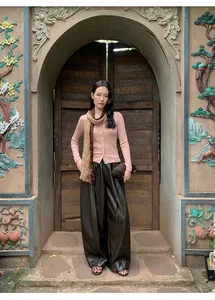 Asian model wearing a pink slim-fit knit cardigan with a brown scarf