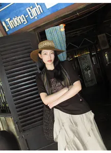 Detailed outdoor view of a woman wearing a beige asymmetric textured layered skirt