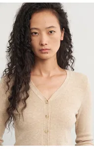 Soft beige knitted cardigan for women with slim fit and button-up V-neck detail.