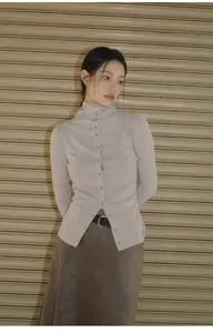 Model showcasing a Maillard style vintage brown asymmetric midi skirt with a beige top