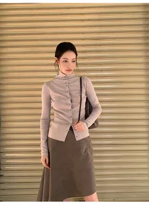 Detail view of a vintage brown asymmetric A-line skirt styled with a lilac cardigan.